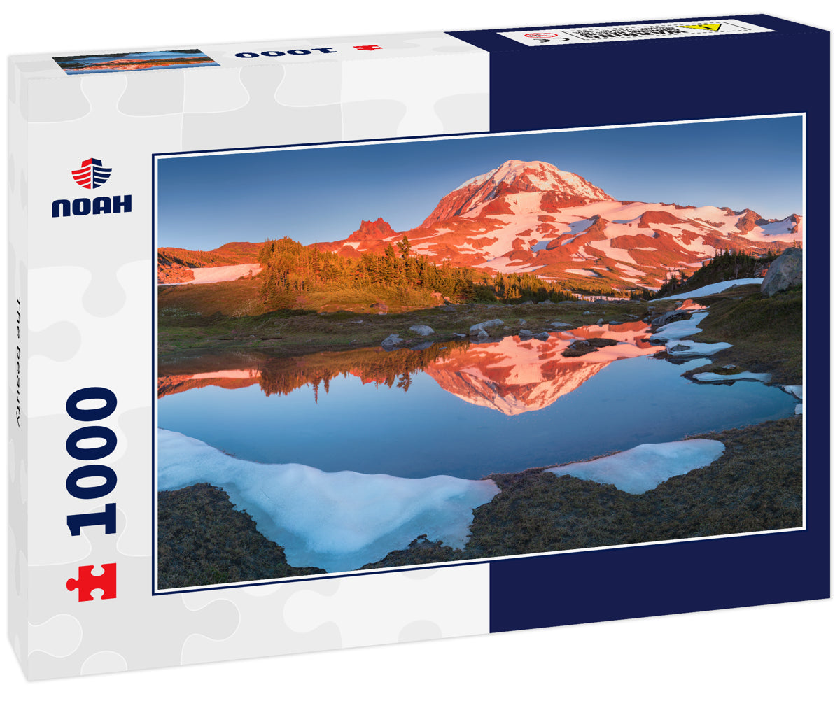 The beauty & tranquility of a summer evening at Mount Rainier National Park. Tall evergreen trees that line an alpine lake & blue sky are reflected on the calm water, Spray Park, Washington State, USA