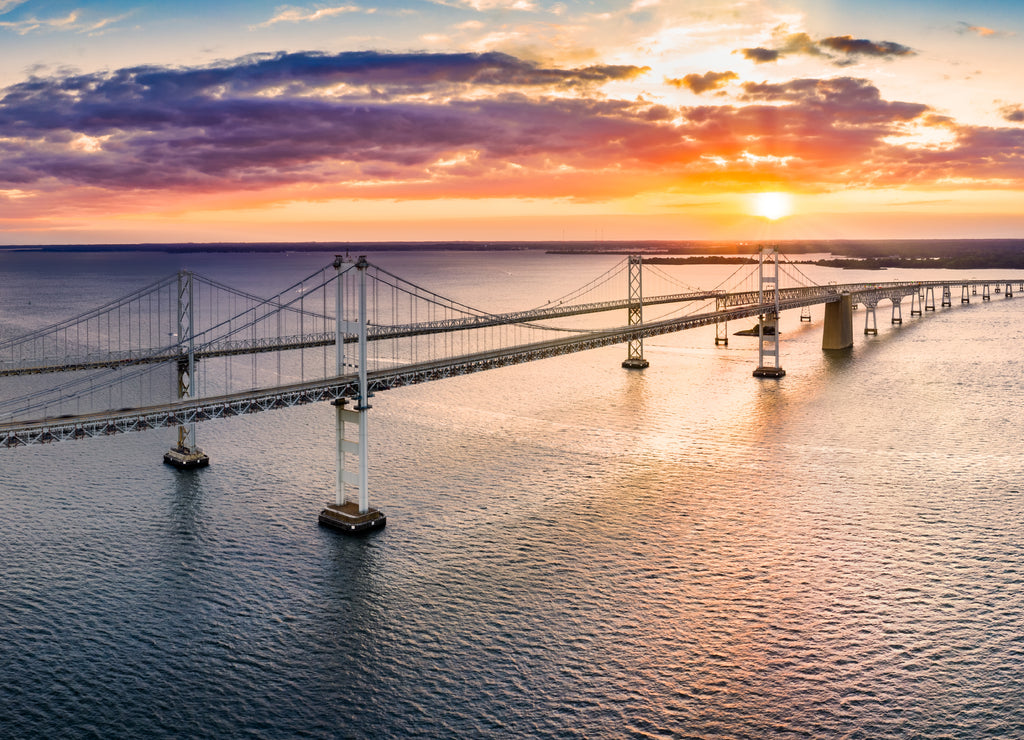 Aerial panorama of Chesapeake Bay Bridge at sunset. The Chesapeake Bay Bridge (known locally as the Bay Bridge) is a major dual-span bridge in the U.S. state of Maryland