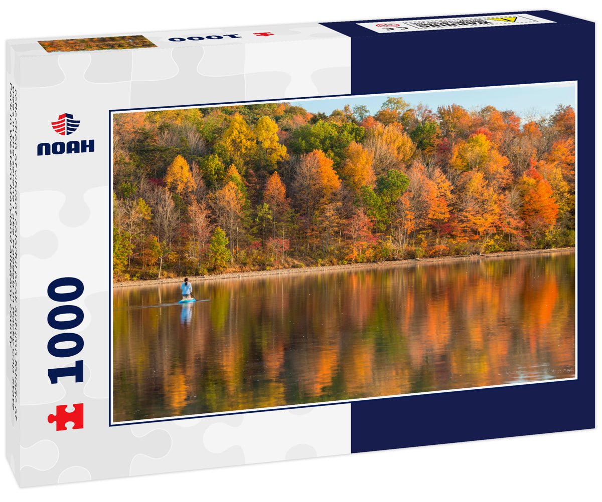 reflection of vibrant colorful peak autumn foliage of trees in the serene Lake Habeeb in Rocky Gap State Park in Western Maryland Allegany county