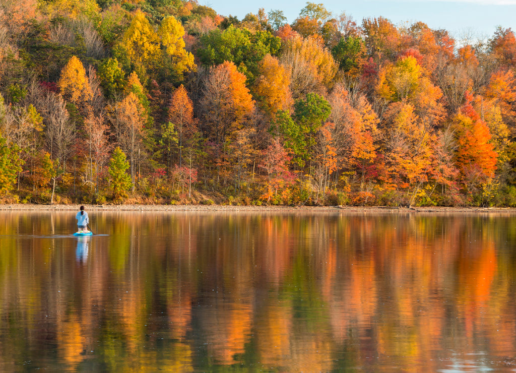reflection of vibrant colorful peak autumn foliage of trees in the serene Lake Habeeb in Rocky Gap State Park in Western Maryland Allegany county