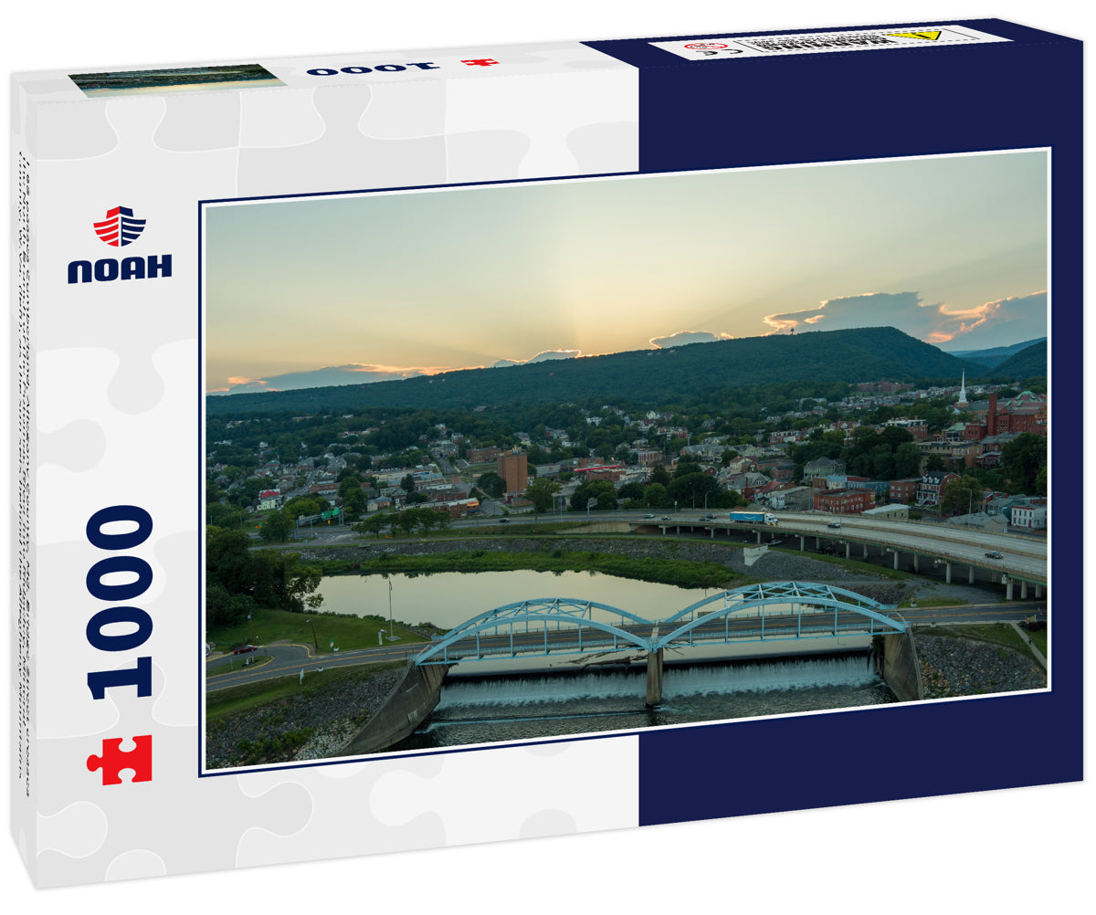 I-68 passes Cumberland, Allegany County, Md. Bridge Street crosses the North Branch of the Potomac River into Ridgeley, Mineral County, W.Va. (left), as the sun sets behind the Allegheny Mountains