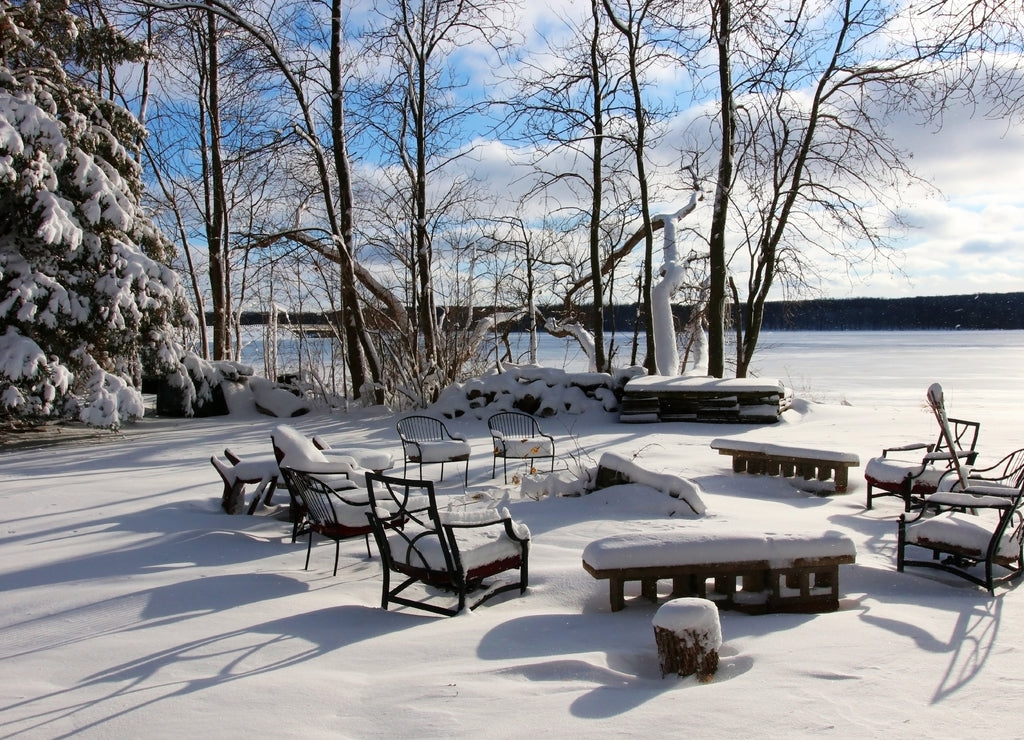 Beautiful Midwest snowy winter nature background. Scenic rural view with covered by fresh snow backyard of the private house with outdoor furniture. Wisconsin countryside, Wausau area