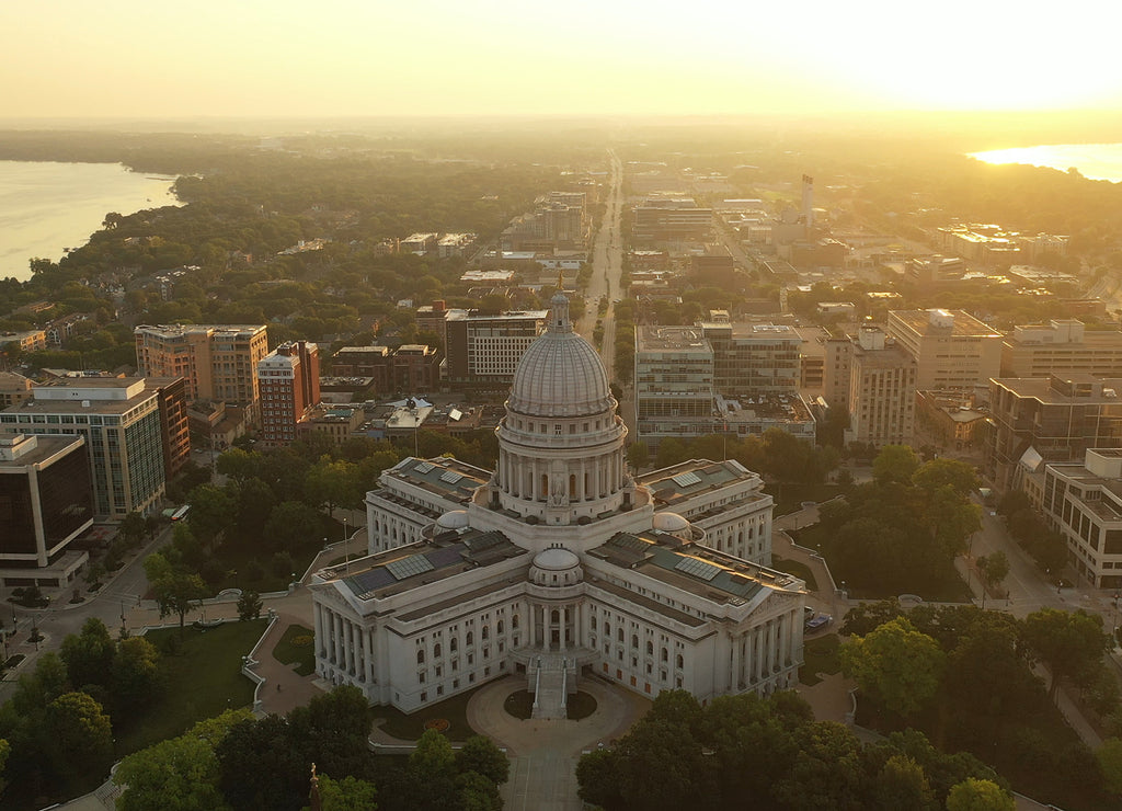 Aerial view of City of Madison. The capital city of Wisconsin from above. Drone flying over Wisconsin State Capitol in downtown. Sunny morning, sunrise (sunset), sunlight, summertime 