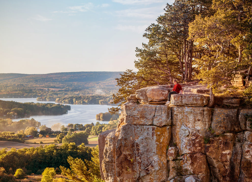 Man sitting on rock outcrop at Gibraltar Rock, Wisconsin