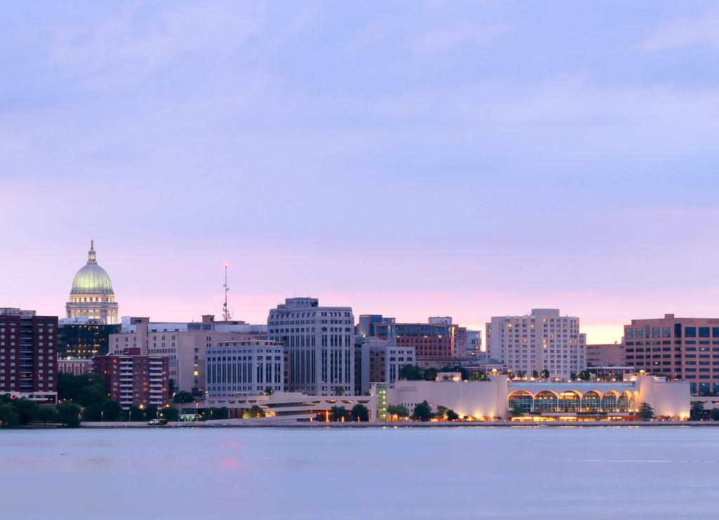 Downtown skyline of Madison, the capital city of Wisconsin, USA. After sunset view with State Capitol building dome against beautiful colored sky from Olin Park