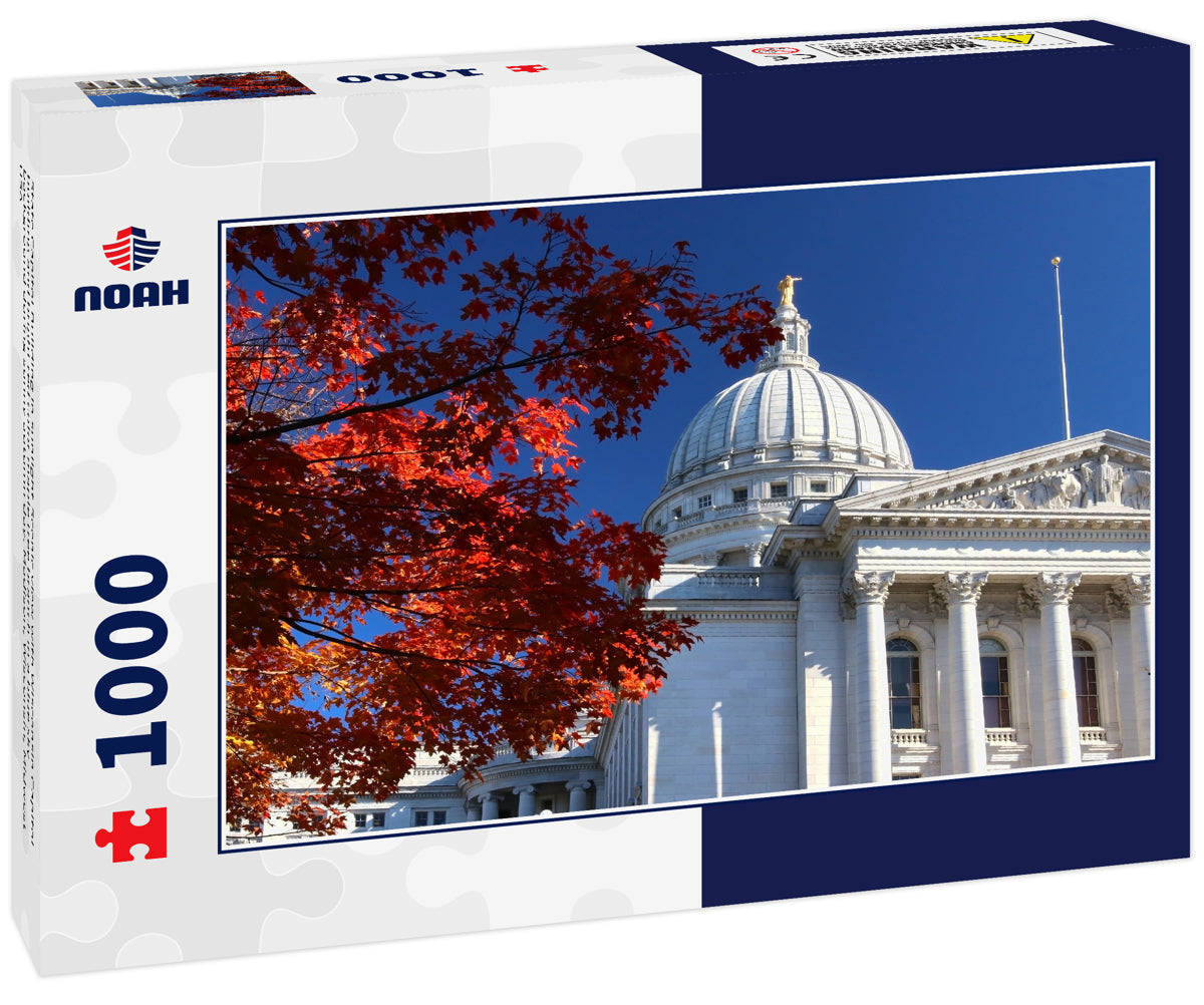 State Capitol Building in sunlight.Scenic view with Wisconsin Capitol building and bright red color maple tree branch in a blue sky background during sunny autumn day. Madison, Wisconsin, Midwest USA