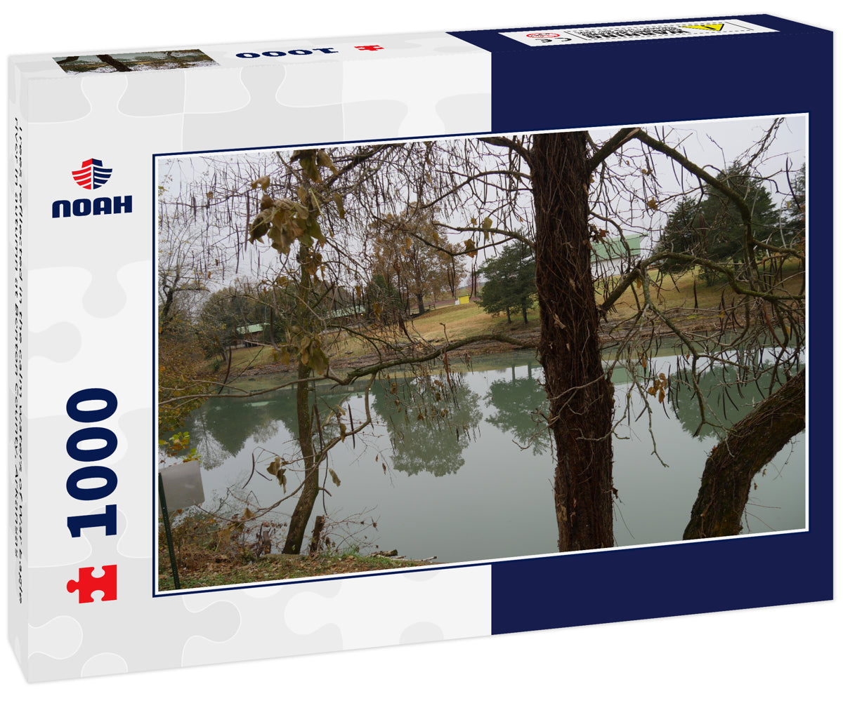 Trees refllected in the calm waters of War Eagle river in autumn at Benton County, Arkansas