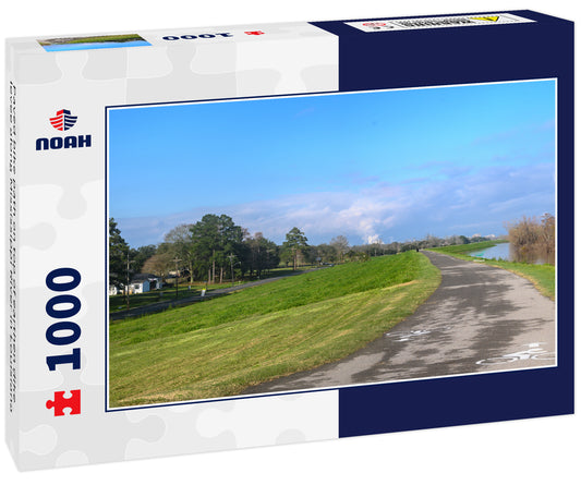 Paved bike path on top of earthen dike levee along Mississippi River in Louisiana