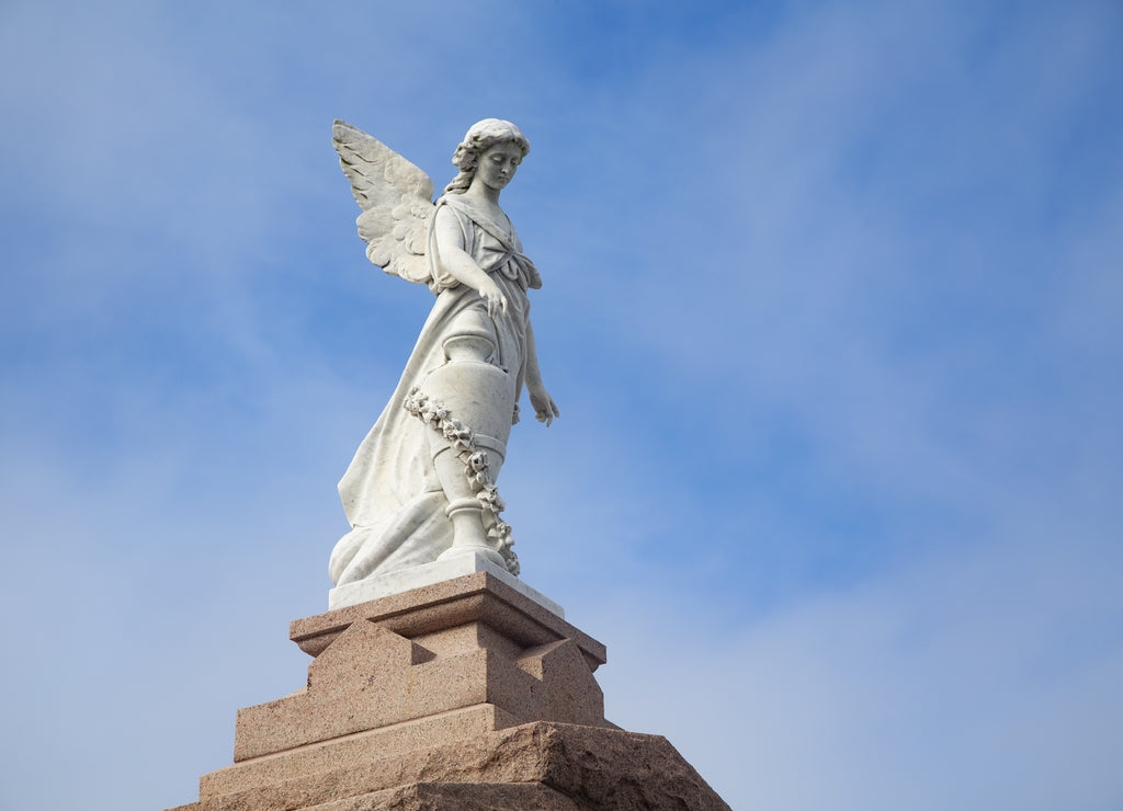 Beautiful shot of the religious statues with the blue sky in the background in New Orleans, Louisiana