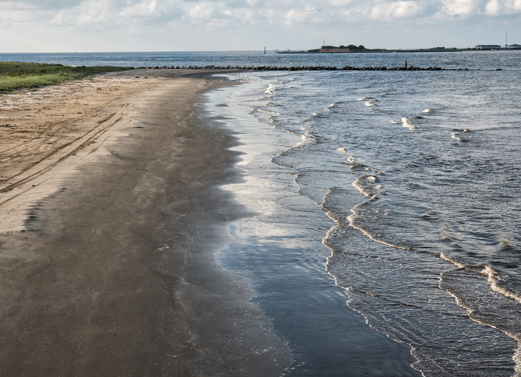 At Grand Isle, Louisiana, the channel entrance to Caminada and Barataria Bays with the ruins of Fort Livingston on Grande Terre Island in the background