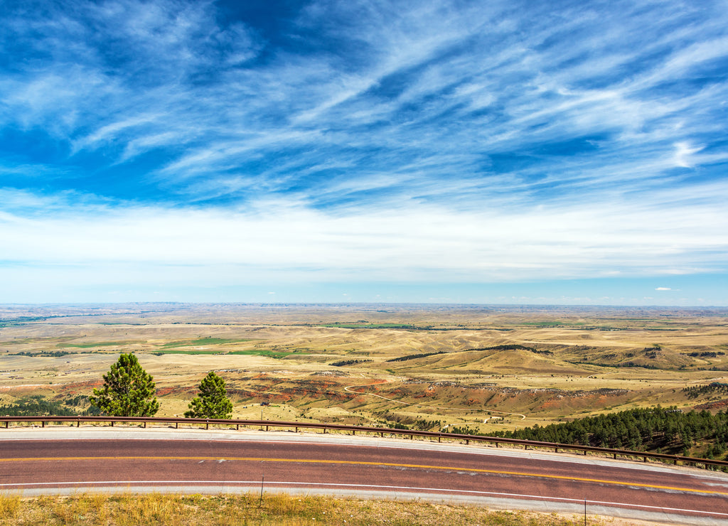 View of a highway with a beautiful landscape and dramatic sky near Sheridan, Wyoming