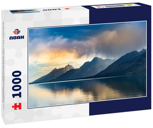 Reflective lake and rocky mountains in Grand Teton National park under the gloomy sky in Wyoming