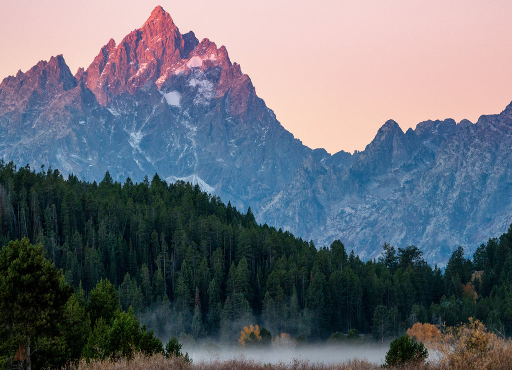 Peak of the Grand Tetons lighting up at sunrise, Wyoming