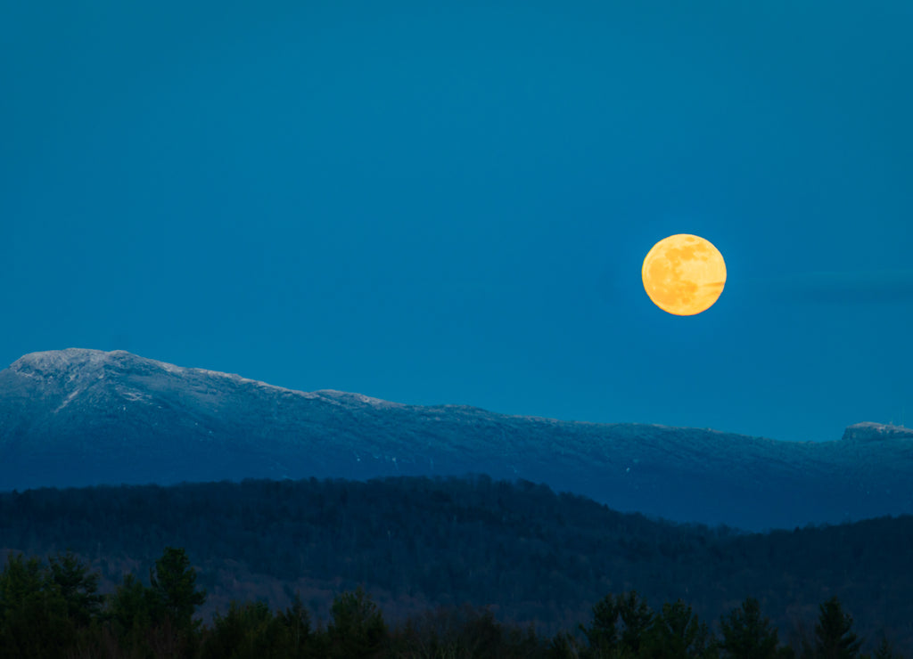 super moon rising over Mount Mansfield in the Green Mountains of Vermont
