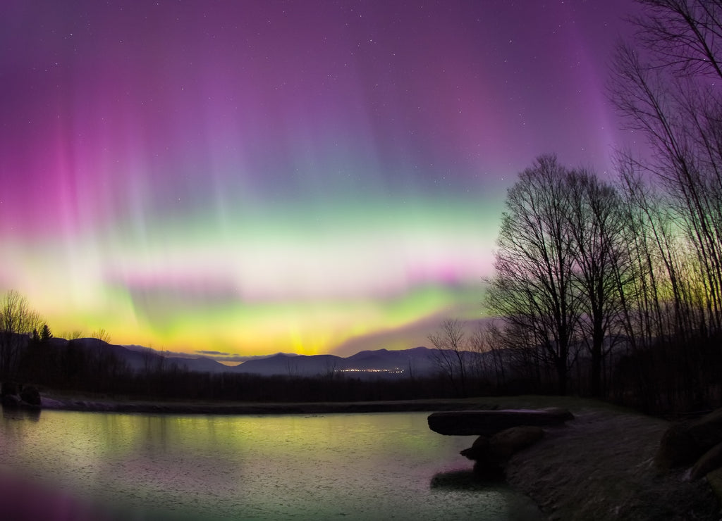 Rare Aurora Borealis over a pond in Vermont