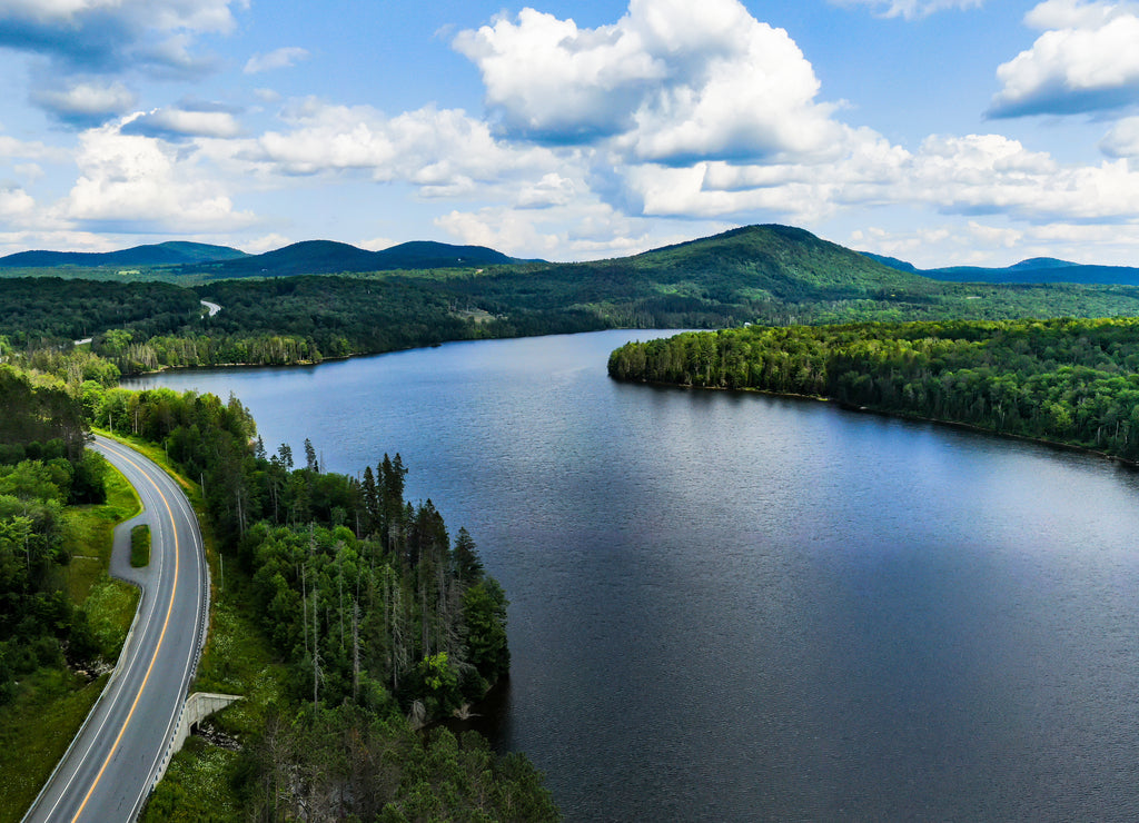 Aerial photography of Vermont`s landscape. Winding roads, embraced by green and pure nature, lakes and mountains