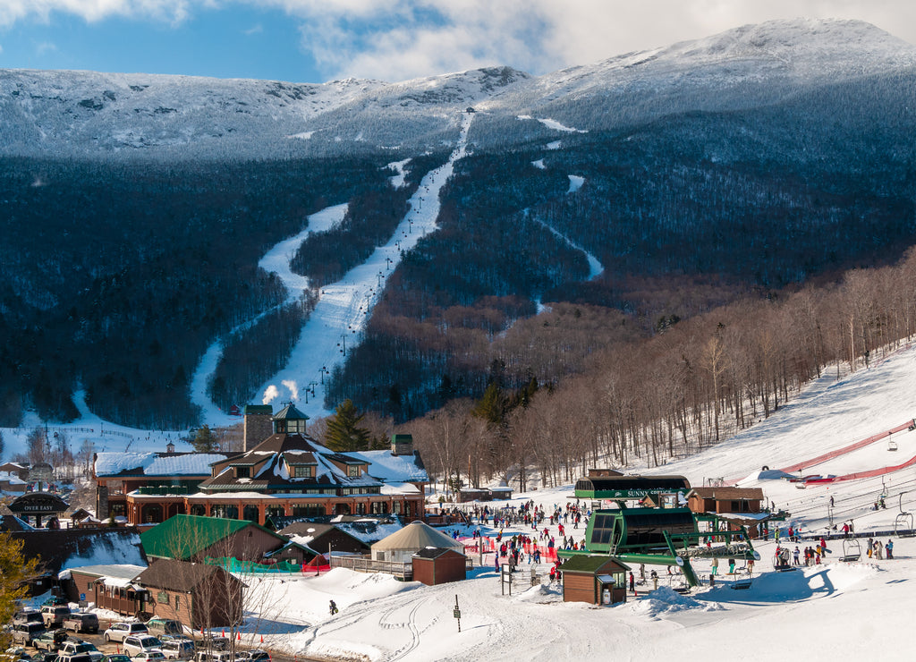 Spruce Peak Lodge in the winter with Mt. Mansfield in the background, Stowe, Vermont, USA