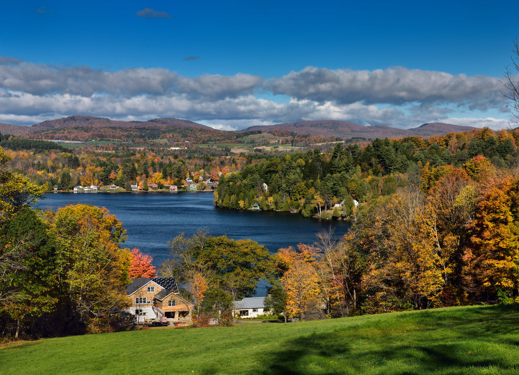 Cottages and houses on Harveys Lake West Barnet Vermont with trees in Fall color