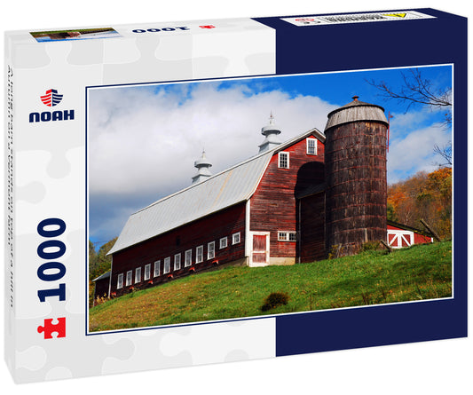 A long barn stands on top of a hill in Autumn on a Vermont farm