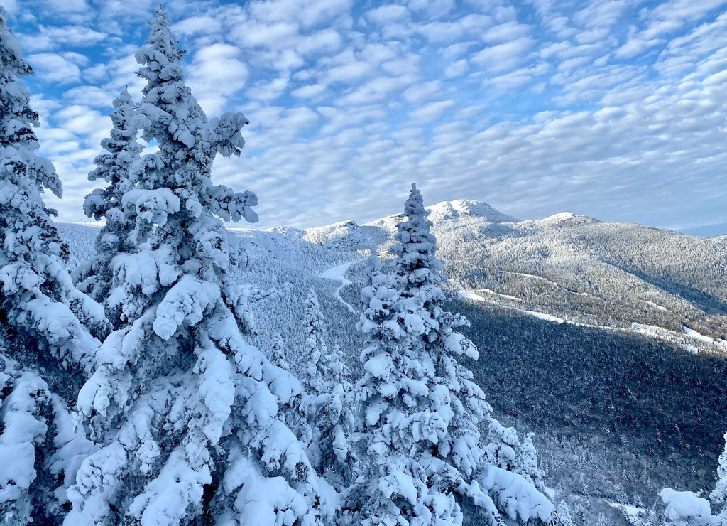 Beautiful sunny day with blue sky and white clouds at the Stowe Mountain Ski resort Vermont - December 2020