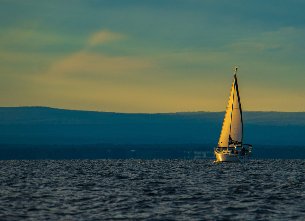 setting sun lights up the sails of schooner on Lake Champlain, Burlington, Vermont