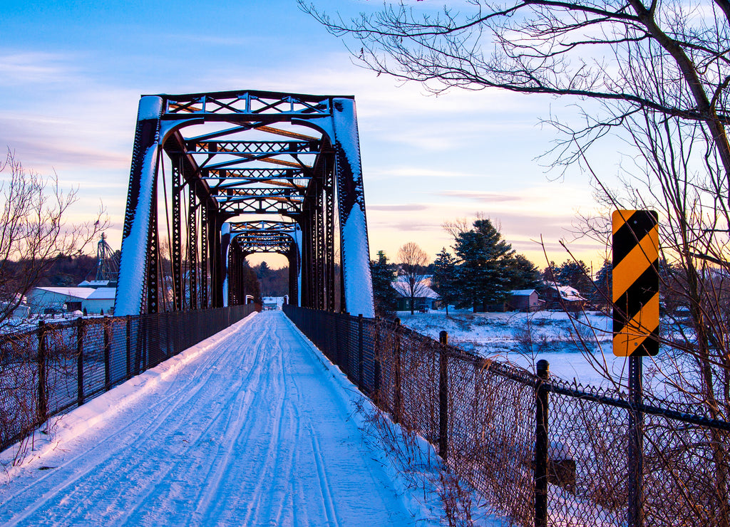 Snow covered bridge at sunset in Vermont