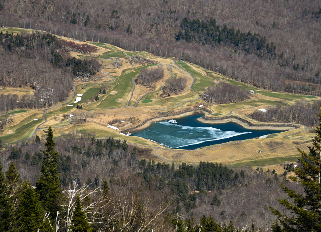 View to the lake down to the valley at spring time skiing in mid April at Stowe Mountain resort, Vermont