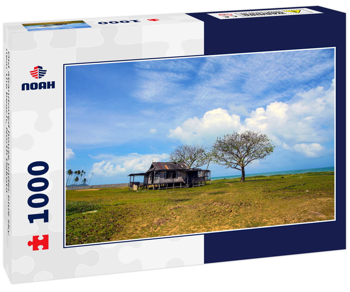 Old abandoned house under blue sky near the beach, North Dakota
