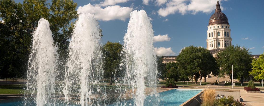 Soft clouds and blue skies appear over fountains and the capitol of Topeka, Kansas USA 2000pc Panoramic Puzzle
