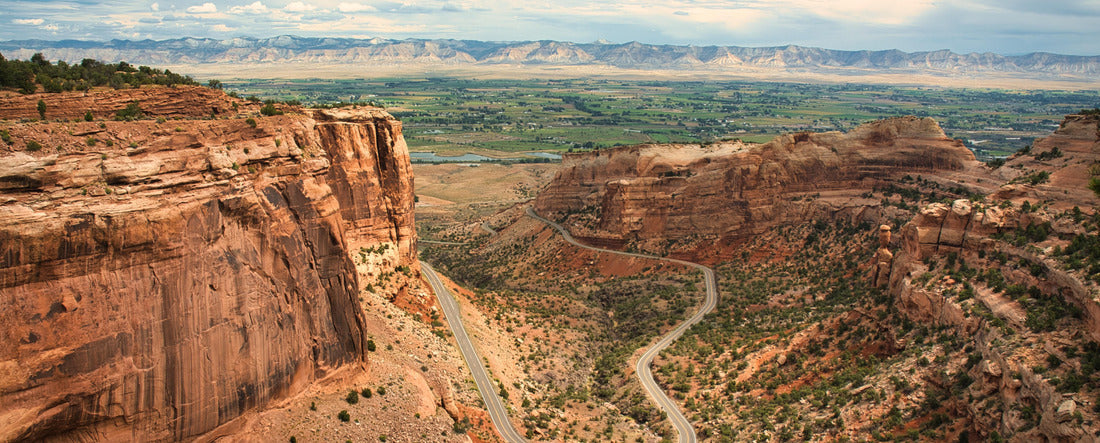 Colorado National Monument preserves one of the grand landscapes of the American West. curvy highway in the valley 2000pc Panoramic Puzzle