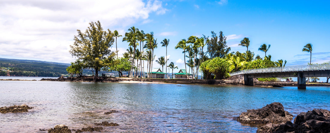 Coconut Island Hawaii depicts a calm day with gentle waves washing ashore highlighting the tropical climate and look of paradise 2000pc Panoramic Puzzle