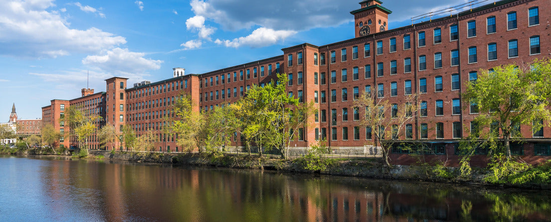 Historical building of a cotton factory with a clock tower in an old industrial park on Nashua River in May. Nashua, New Hampshire 2000pc Panoramic Puzzle