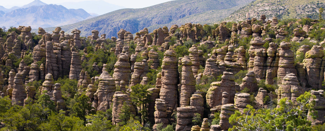 Arizona's Chiricahua National Monument rocky formations with mountains behind them, near Wilcox, in Cochise County, USA, not far from the border with Mexico 2000pc Panoramic Puzzle