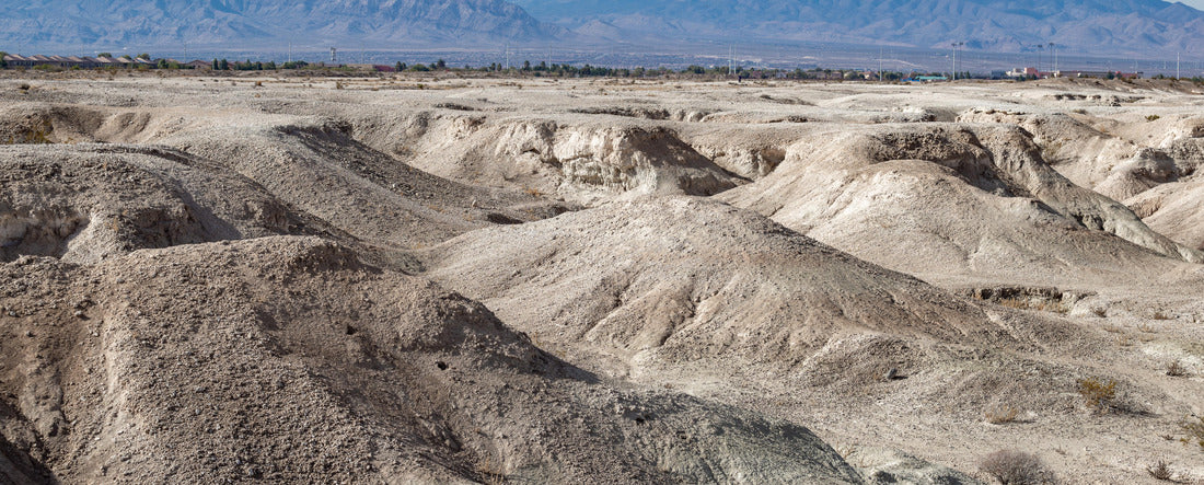 USA, Nevada, Clark County, Tule Fossil Beds National Monument: White gypsum hills at the urban fringe along the Las Vegas Wash with Mt. Charleston in the distance 2000pc Panoramic Puzzle
