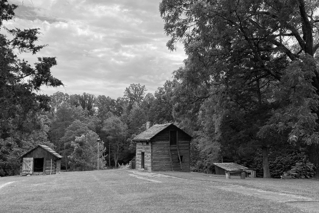 Slave cabin at Booker T. Washington National Monument in rural Virginia. Tobacco farm where educator and leader Booker T. Washington was born into slavery and later freed by Emancipation Proclamation 2000pc PuzzleBlack and White