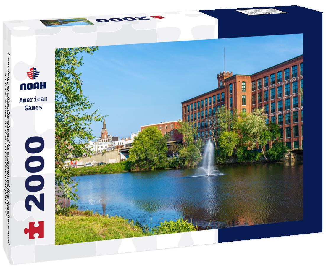 Noah Jigsaw Puzzle Fountain on the Nashua River against the background of a historic cotton factory building with a clock tower in the old industrial park of Nashua. New Hampshire 2000 pieces