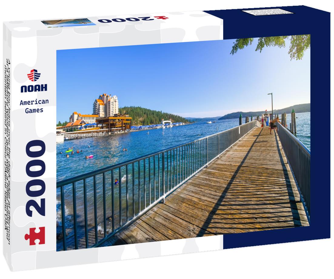 Noah Jigsaw Puzzle A young boy leans over the dock edge at afternoon at a lakefront wooden dock with a hotel resort and mountain behind in Coeur d'Alene Idaho USA 2000 pieces