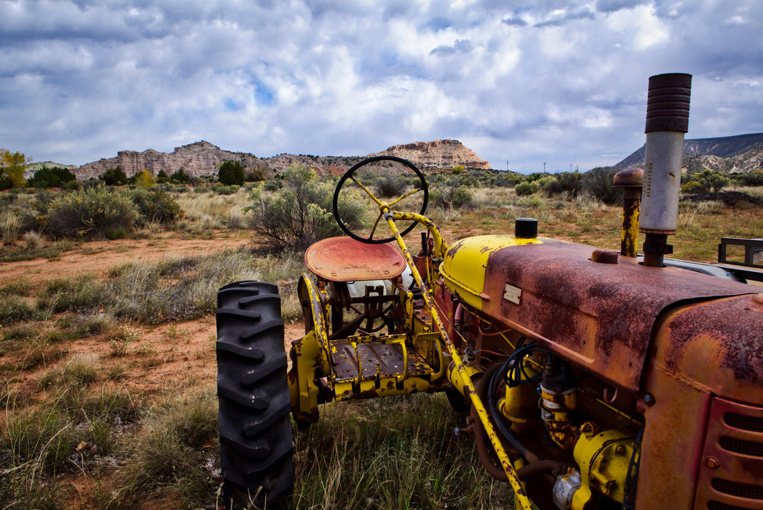A textured and colorful old tractor sits in the New Mexico desert, with mesas and cloud-filled sky in the background 2000pc Puzzle