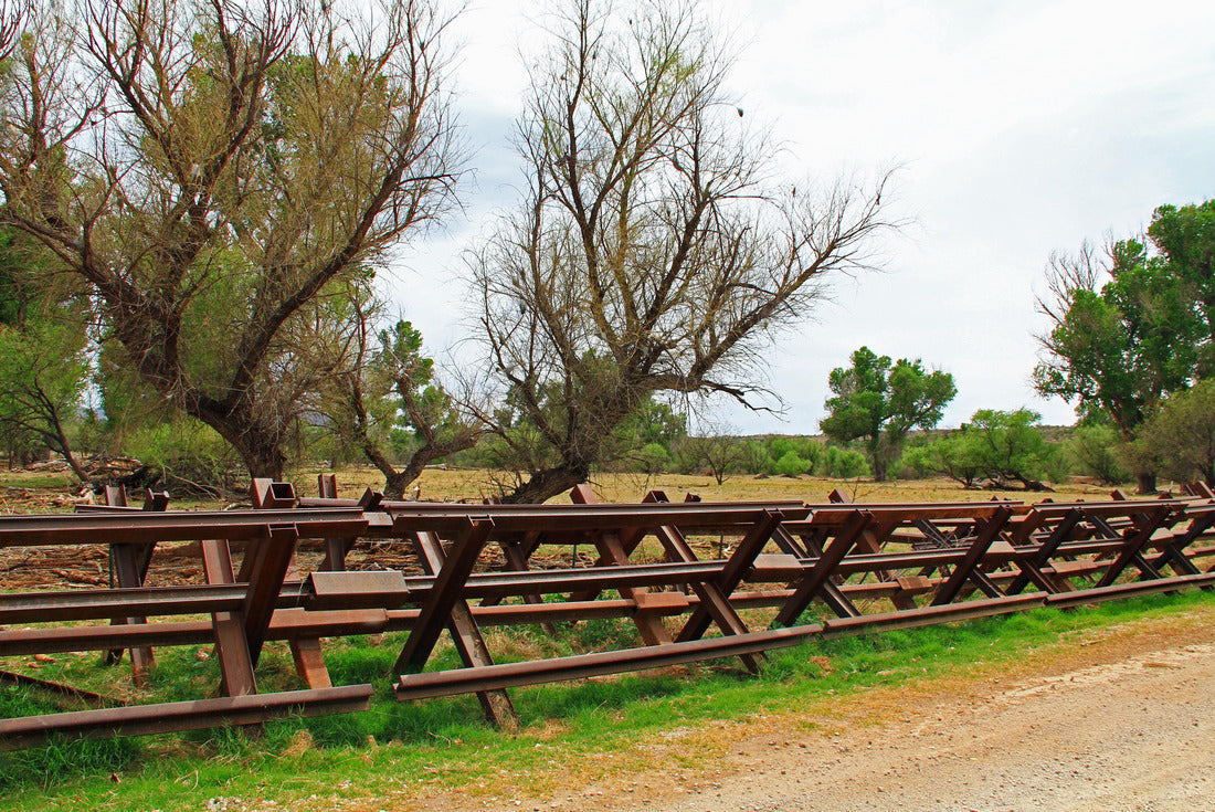 Dry river bed with a river border Fence beside a road near Nogales, Arizona separating the United States from Mexico 2000pc Puzzle