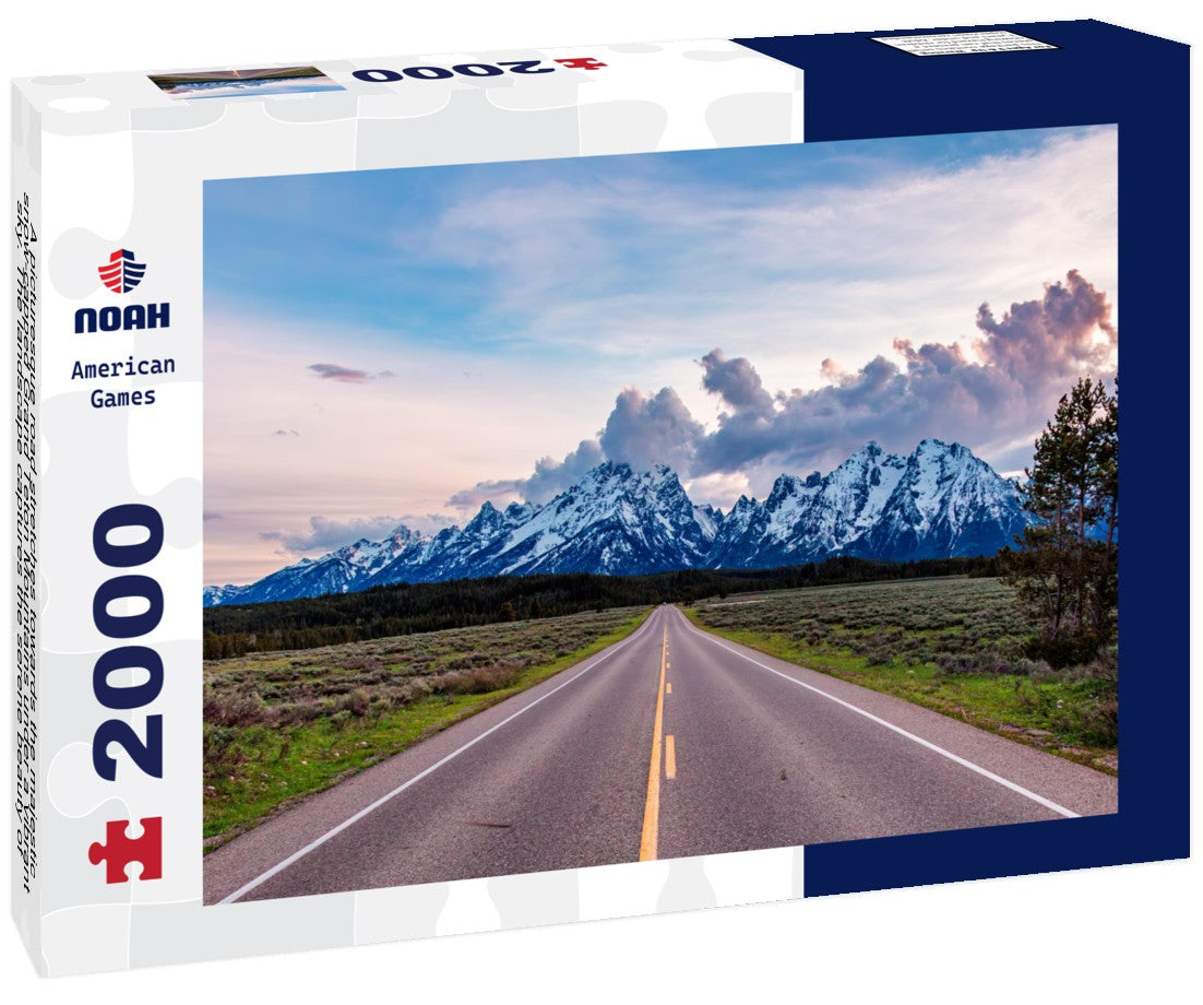 Noah Jigsaw Puzzle A picturesque road stretches towards the majestic, snow-capped Grand Teton Mountains under a vibrant sky. The landscape captures the serene beauty of Wyoming, evoking feelings of adventure 2000 pieces