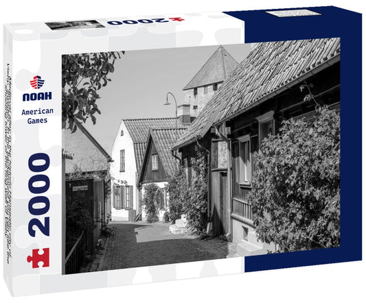 Noah Jigsaw Puzzle Medieval alley in the historic Hanseatic city of Visby, Sweden. In the background you can see the shooting tower of the ring wall of Visby, a UNESCO World Heritage Site in black white 2000 pieces