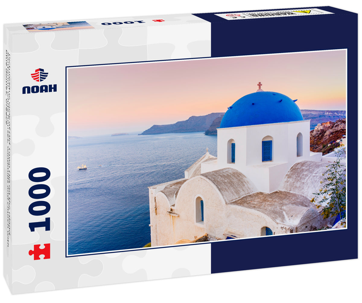 Picturesque view of Old Town Oia on the island Santorini, white houses, windmills and church with blue domes, Greece