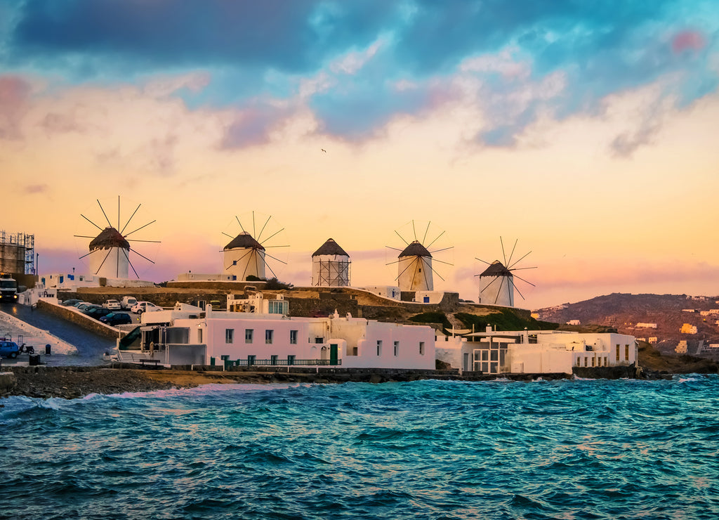 Sunset view of Mykonos seafront with windmills