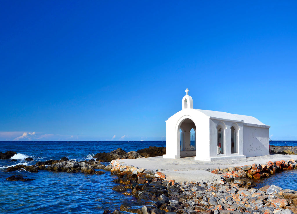 Small white church in sea near Georgioupolis town on Crete, Greece