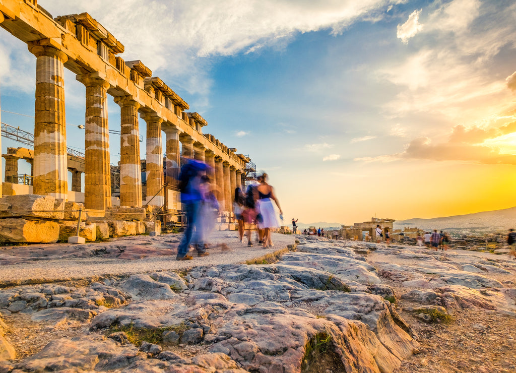 People in motion blur walking around the ruins of Parthenon temple in Athens, Greece