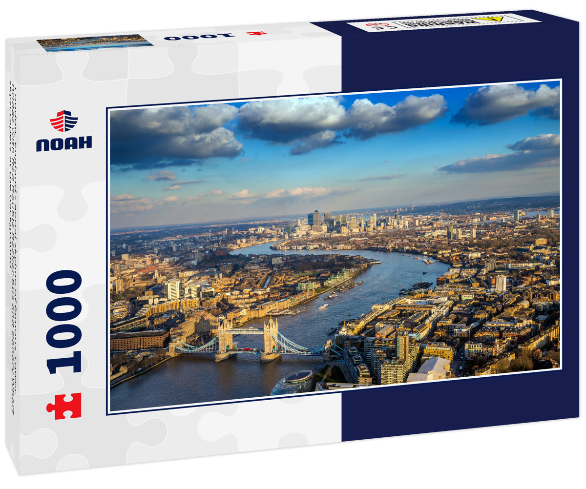 London, England - Aerial skyline of famous Tower Bridge with Red Double Decker bus and Canary Wharf skyscrapers at the background