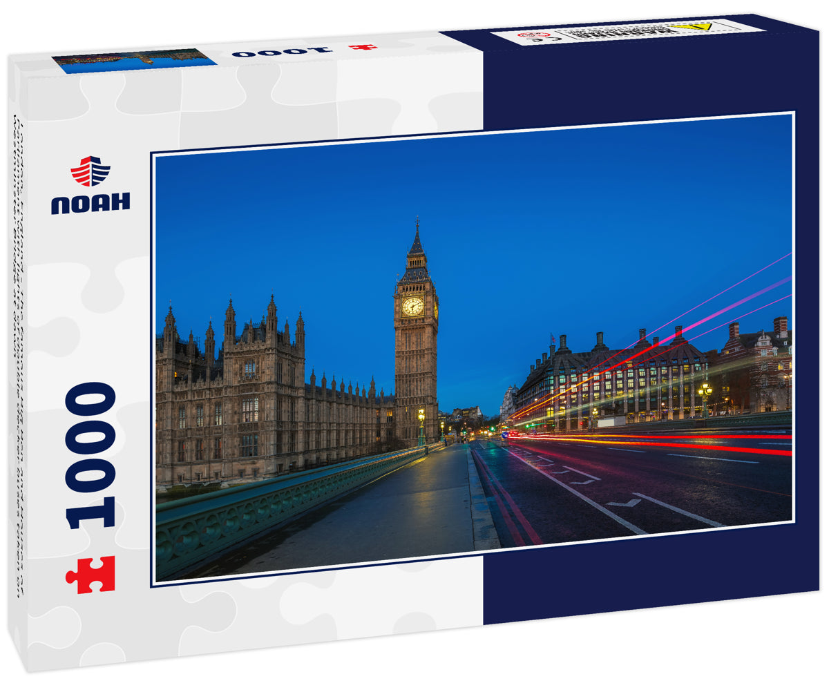 London, England - The famous Big Ben and Houses of Parliament with lights of double decker buses taken on Westminster Bridge at dawn