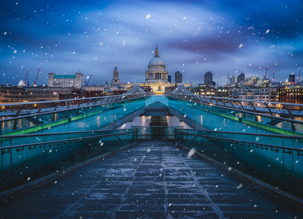 Millenium bridge on a cold winter morning with falling snow, London, United Kingdom