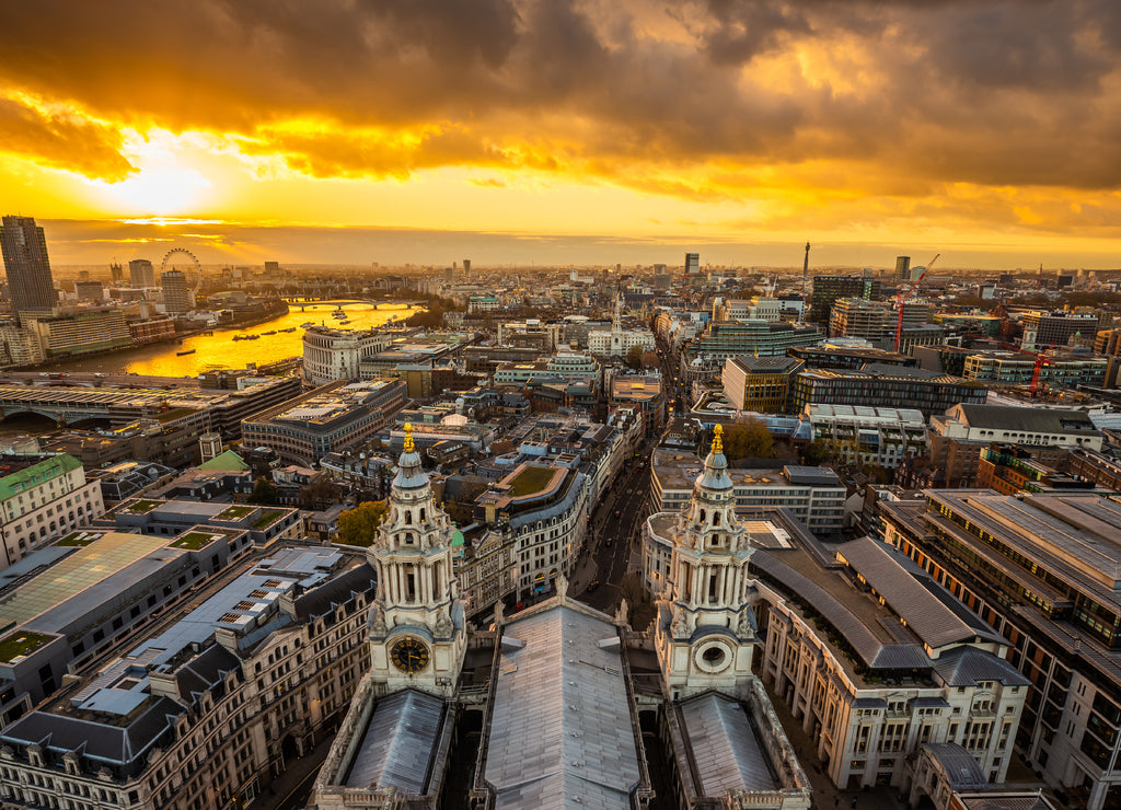 London, England - Aerial panoramic skyline view of London taken from top of St.Paul's Cathedral at sunset with beautiful golden sky and clouds