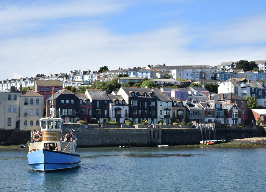 Ferry boat with Cornish fishing village at the background. Falmouth is the Cornish transport hub as trains run from Truro, there are buses and ferries to St Mawes, Trelissick and Truro. United Kingdom